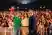 Three people pose together in front of a crowd