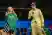 A man and a woman holding a shirt on a stage