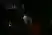 A man hanging from a dark stage